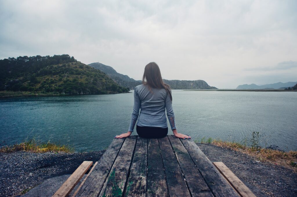 woman sitting on the dock